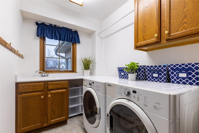 laundry room featuring a sink, cabinet space, and independent washer and dryer