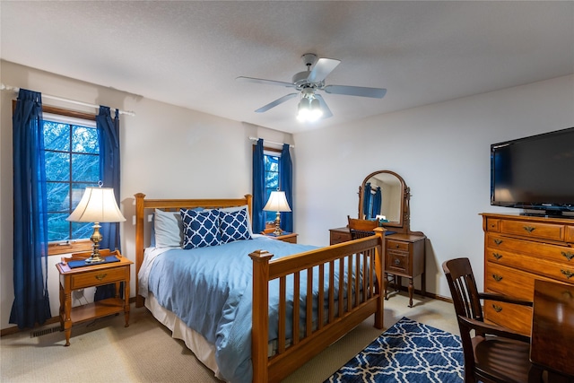 bedroom featuring baseboards, a ceiling fan, and carpet