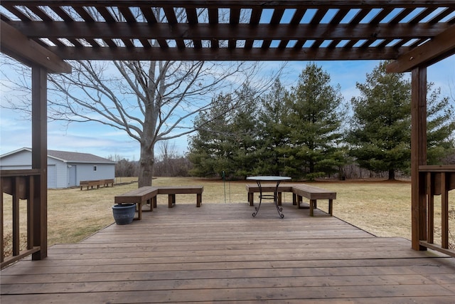 deck featuring an outbuilding, a lawn, and a pergola