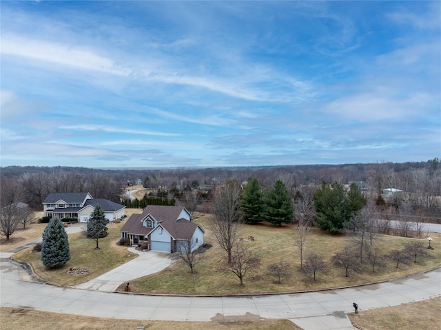 birds eye view of property featuring a view of trees