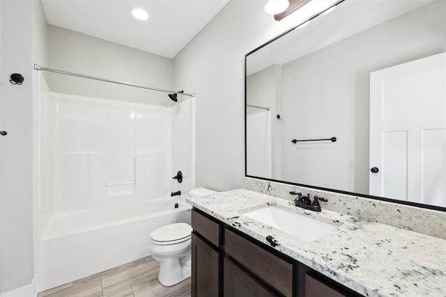 full bathroom featuring shower / washtub combination, hardwood / wood-style floors, vanity, and toilet