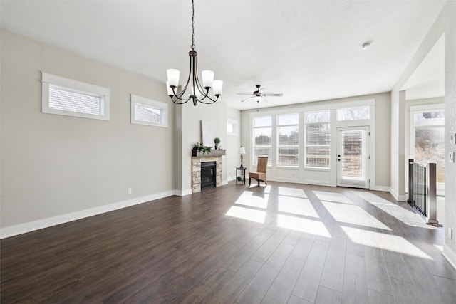 unfurnished living room featuring hardwood / wood-style flooring, a notable chandelier, and a fireplace