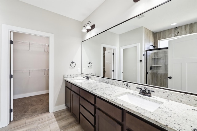 bathroom featuring an enclosed shower and vanity