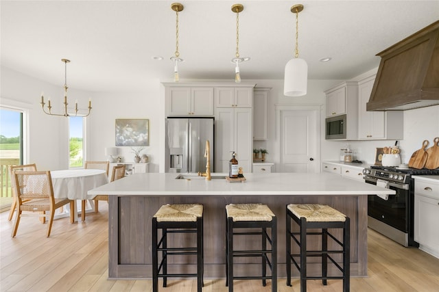 1083 NW 35th St, Grimes, IA 50111 - kitchen with appliances with stainless steel finishes, custom range hood, an island with sink, light countertops, and recessed lighting
