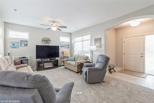 carpeted living room with ceiling fan