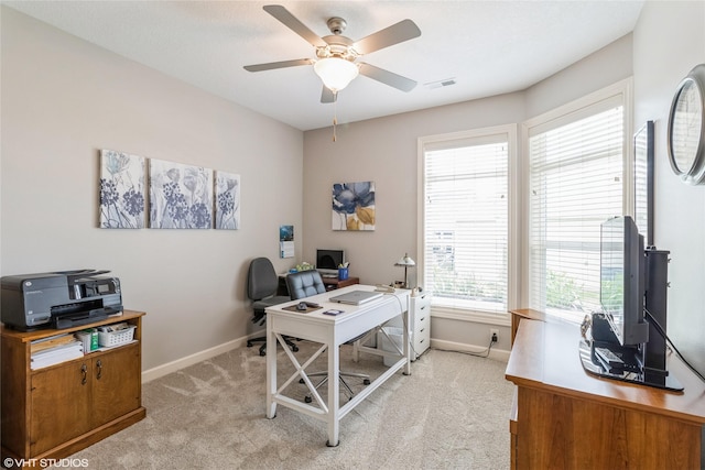 office space featuring light colored carpet and ceiling fan