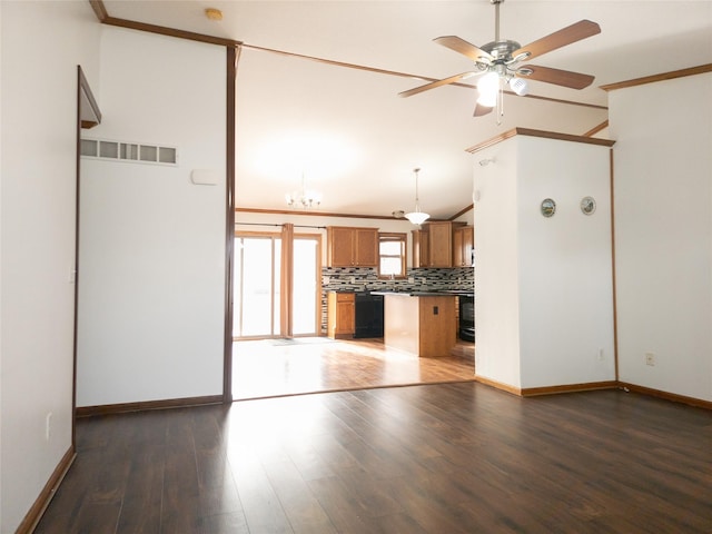 unfurnished living room featuring ceiling fan, ornamental molding, dark hardwood / wood-style flooring, and vaulted ceiling