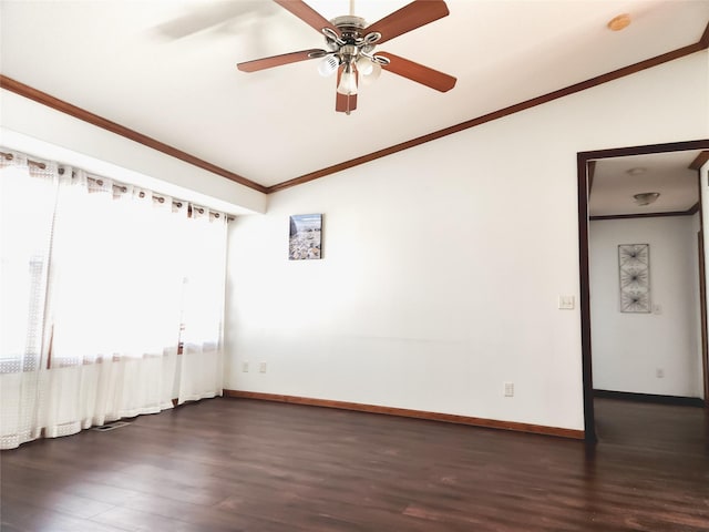 spare room with dark wood-type flooring, vaulted ceiling, ornamental molding, and ceiling fan