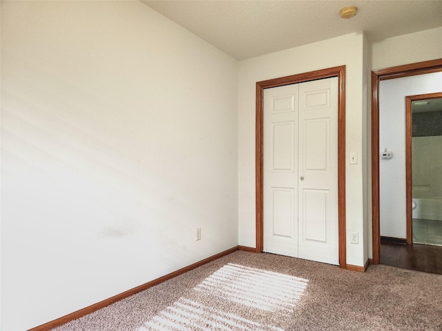 unfurnished bedroom with a closet and carpet