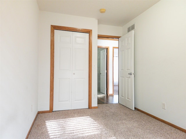 unfurnished bedroom with carpet floors and a closet