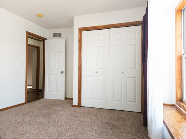 unfurnished bedroom with carpet floors and a closet