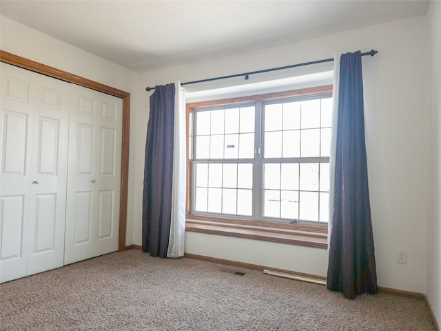 unfurnished bedroom featuring carpet floors and a closet