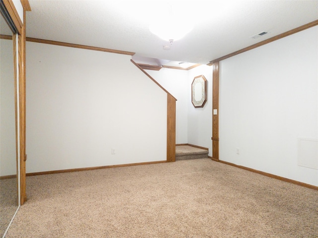 basement featuring ornamental molding and carpet floors