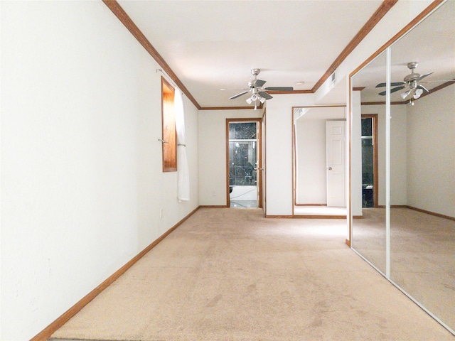 interior space featuring crown molding, carpet floors, and ceiling fan