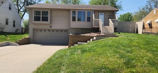 5804 Snyder Ave, Des Moines, IA 50322 - view of front of property with concrete driveway, a garage, and a front yard