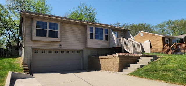 5804 Snyder Ave, Des Moines, IA 50322 - view of front of property with stairway, a garage, and driveway