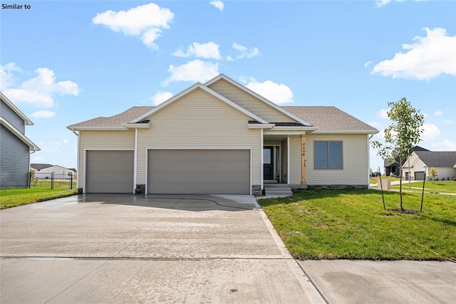 view of front of house with a garage and a front yard