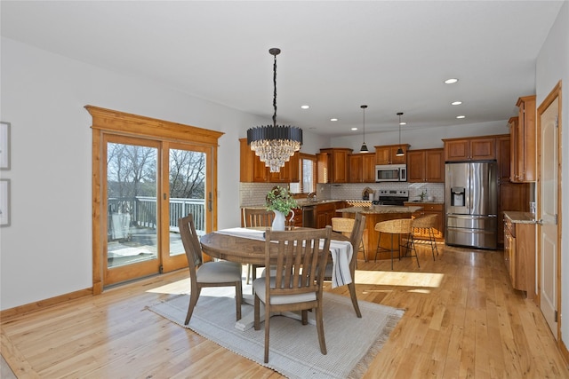 dining room with an inviting chandelier and light hardwood / wood-style floors