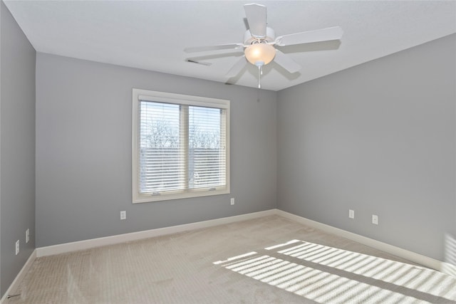 spare room with light carpet and ceiling fan