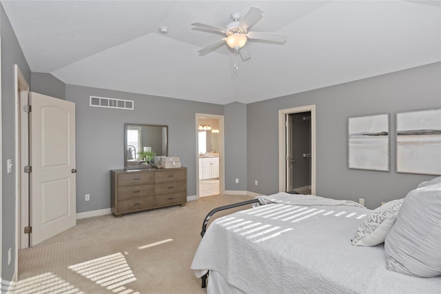 carpeted bedroom featuring lofted ceiling, connected bathroom, and ceiling fan