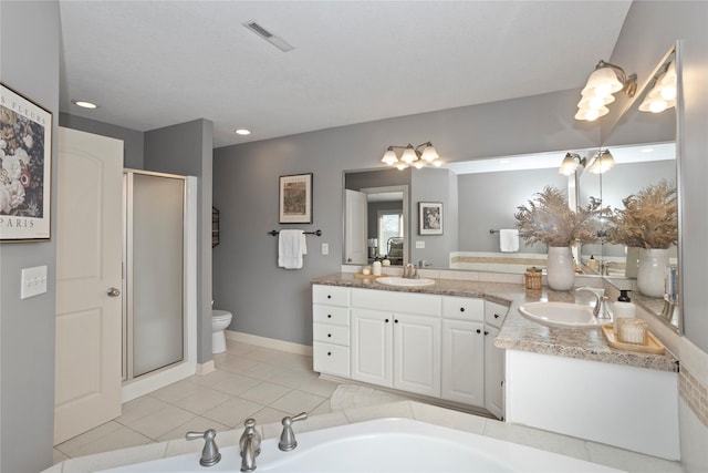 bathroom featuring tile patterned flooring, vanity, an enclosed shower, and toilet