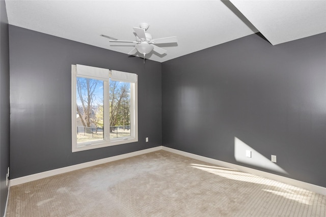 carpeted spare room with ceiling fan