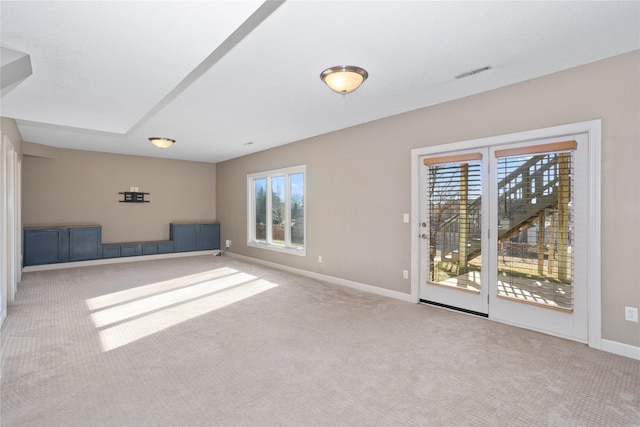 unfurnished room with light carpet and a wealth of natural light