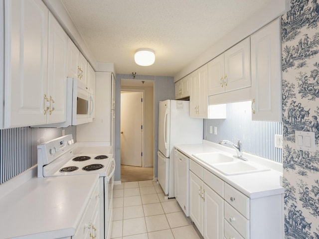 kitchen with white cabinetry, sink, white appliances, and a textured ceiling