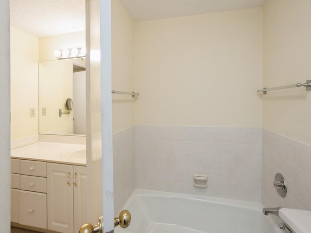 bathroom with a bathing tub and vanity