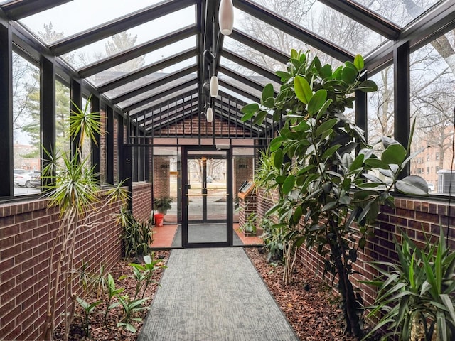 doorway to property featuring brick siding