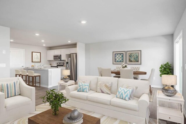 living room with sink and light hardwood / wood-style flooring