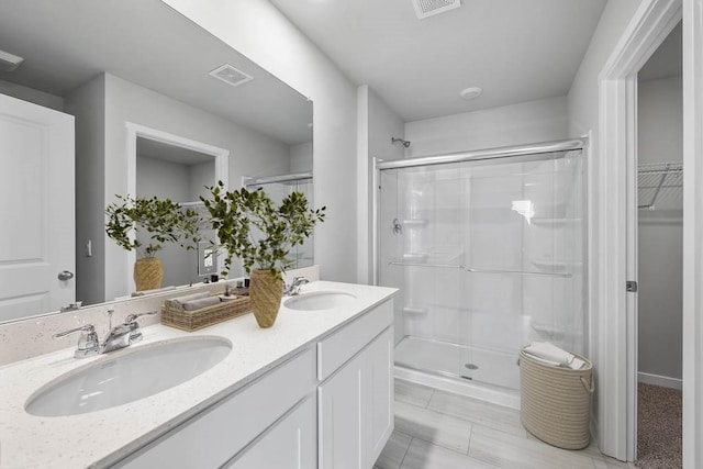 bathroom featuring an enclosed shower, vanity, and tile patterned floors