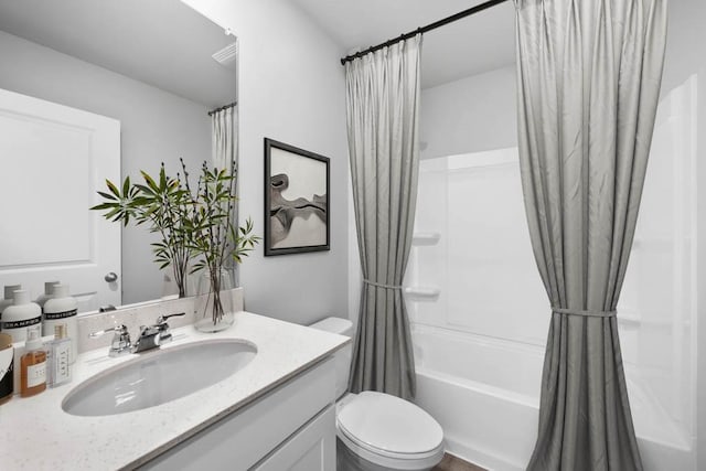 full bathroom with vanity, shower / bath combination with curtain, and toilet
