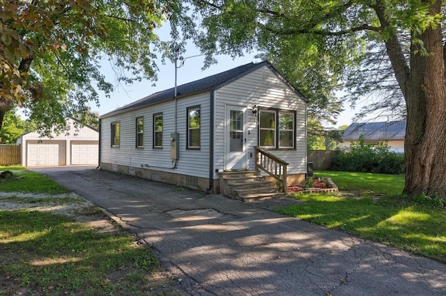 view of front facade featuring a garage, an outdoor structure, and a front yard