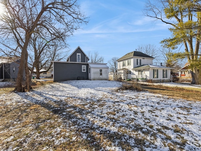 view of snow covered rear of property