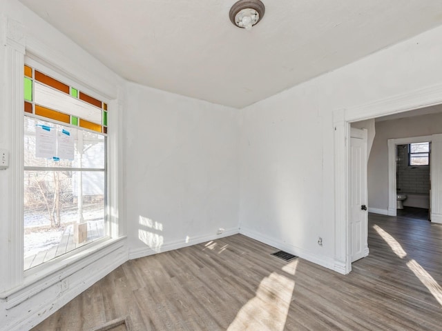 spare room featuring hardwood / wood-style floors