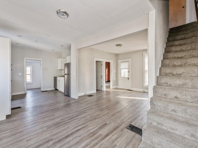 unfurnished living room with light hardwood / wood-style flooring