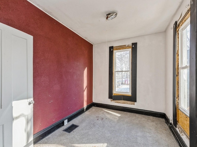 unfurnished room featuring carpet floors and a wealth of natural light