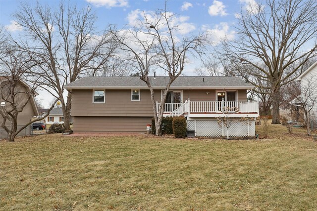 back of house featuring a wooden deck and a lawn