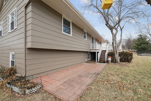 view of home's exterior featuring a lawn and a patio area