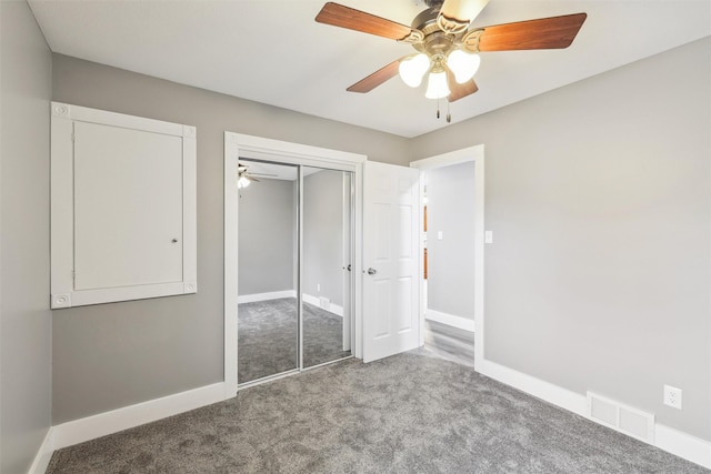 unfurnished bedroom with ceiling fan, light colored carpet, and a closet