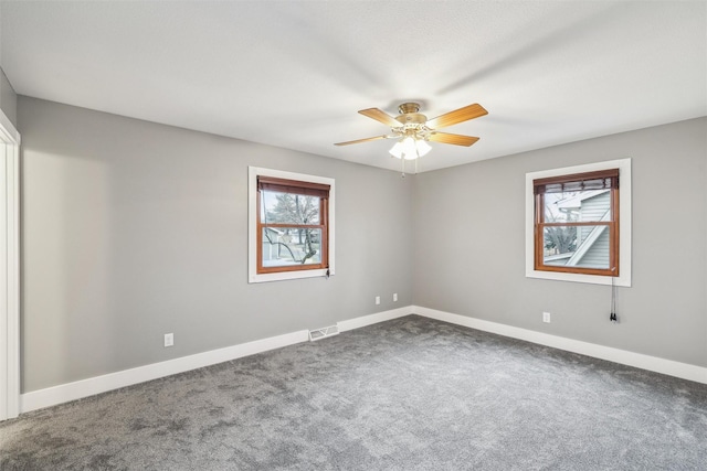 carpeted spare room with ceiling fan