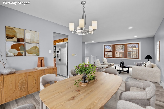 dining room with an inviting chandelier, light wood-style flooring, and recessed lighting