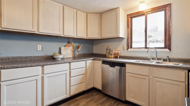 kitchen featuring sink, stainless steel dishwasher, a textured ceiling, and dark hardwood / wood-style floors