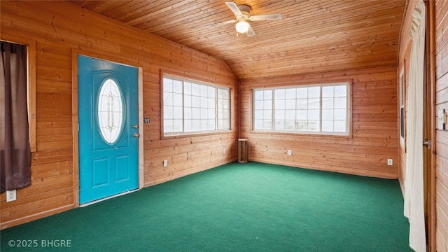 entrance foyer featuring wood ceiling, vaulted ceiling, and wood walls