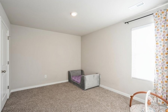 sitting room featuring light carpet