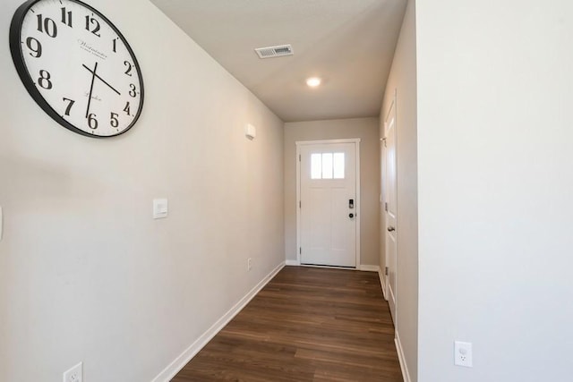 entryway with dark hardwood / wood-style flooring