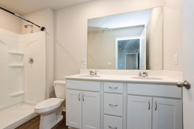 bathroom with walk in shower, vanity, toilet, and hardwood / wood-style floors