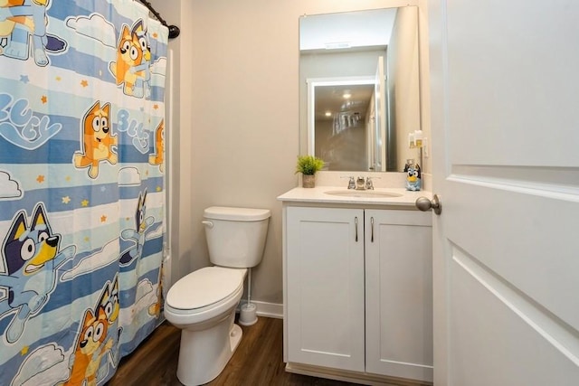 bathroom featuring vanity, wood-type flooring, and toilet