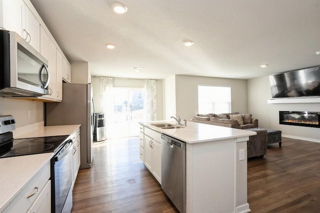 kitchen featuring sink, appliances with stainless steel finishes, dark hardwood / wood-style floors, an island with sink, and white cabinets